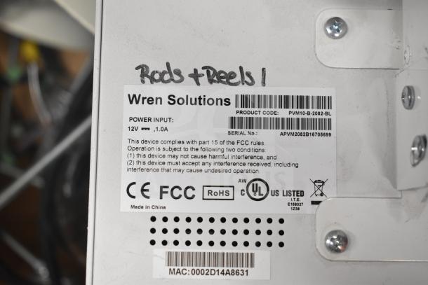 Wren Solutions label on a monitor with product code PVM10-B-2082-BL, 12V input, and compliance markings.