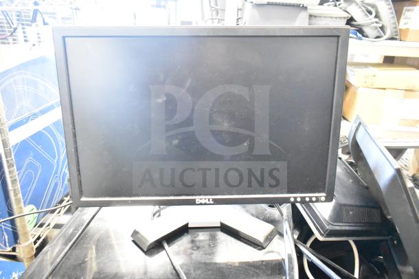 Dell computer monitor with visible screen wear, part of a lot including Onn and HP monitors. Auction for 27 units.