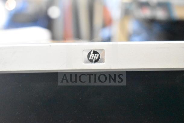 HP monitor, silver frame with HP logo, part of auction lot of 27 items including Onn and Dell monitors.