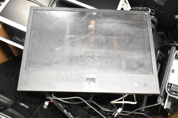 Various computer monitors including Onn, Dell, and HP, showing wear and scratches, with visible cables and partial labels.