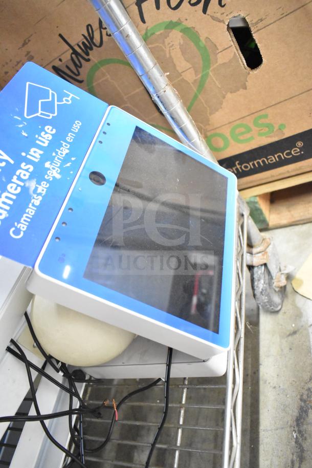 Security system setup with two monitors and cameras, featuring a blue "Cameras in use" label, wires visible, pre-owned.