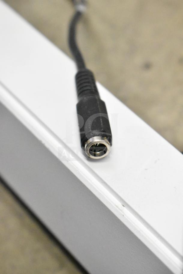 Close-up of a power cable plug on a security system component.