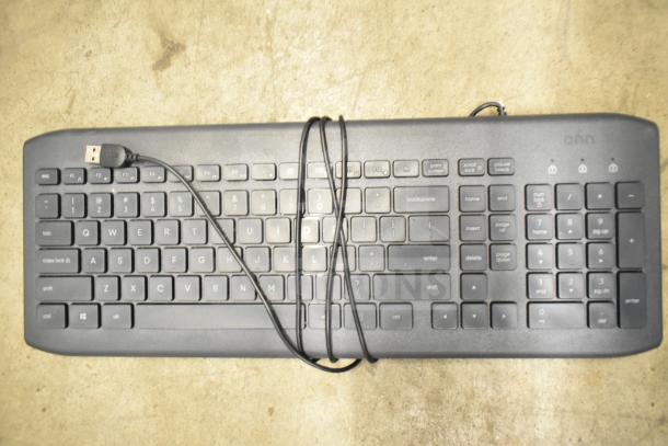Black USB wired computer keyboard, standard layout, with numeric keypad, in used condition.
