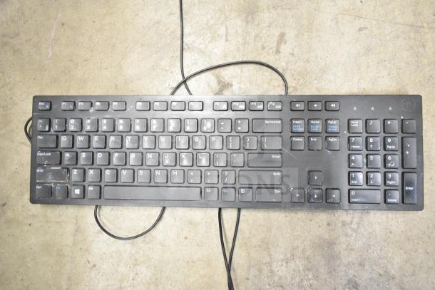 Black computer keyboard with visible wear, featuring a wired connection. Part of a 26-item auction bundle including keyboards and mice.