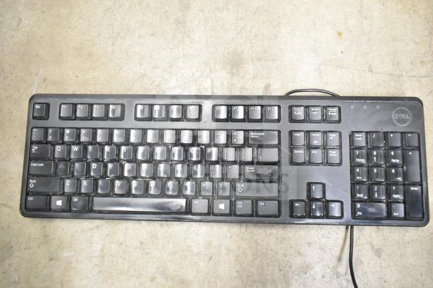 Dell black wired keyboard, full layout, visible wear. Part of a 26-item lot including keyboards and mice.