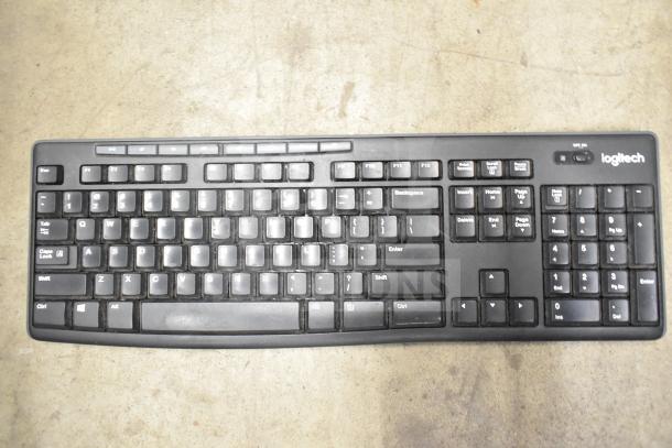 Logitech black computer keyboard, full layout, used condition, visible wear on keys. Part of a 26-item lot.