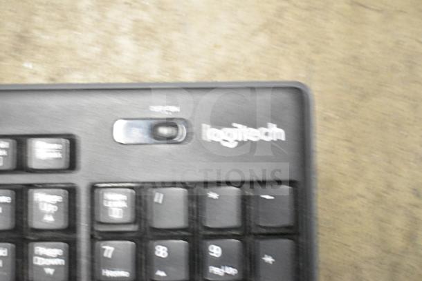Logitech keyboard close-up showing logo and keys; part of a 26-item tech auction lot including keyboards and mouse.