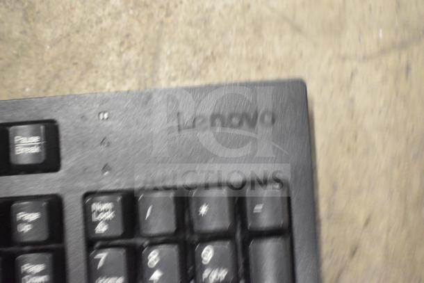 Lenovo keyboard close-up. Includes 26 various items like keyboards and a mouse. Black color, visible Pause Break key.