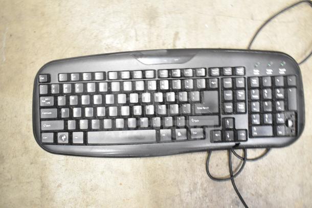Computer keyboard, black, standard layout, wired. Part of auction lot with 26 various items including keyboards and mice.