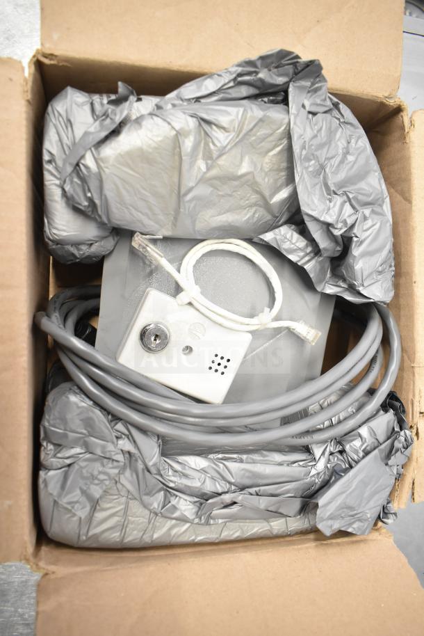 5 various items including Sensormatic ZBSMPCPEF Compact Pad Pro in packaging. Cables and key box included. Moderate condition.