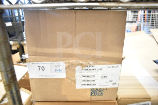 Cardboard box containing Sensormatic ZBSMPCPEF Compact Pad Pro among other items. Labels indicate auction details.