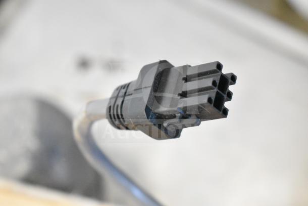 Close-up of a Sensormatic ZBSMPCPEF Compact Pad Pro connector, showing a black multi-pin plug, in good condition.