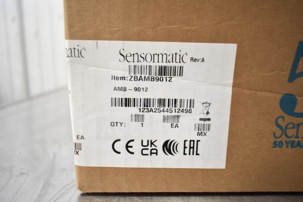 Cardboard box with Sensormatic ZBAMB9012 label, item: 5 mixed items including Sensormatic ZBSMPCPEF Compact Pad Pro.