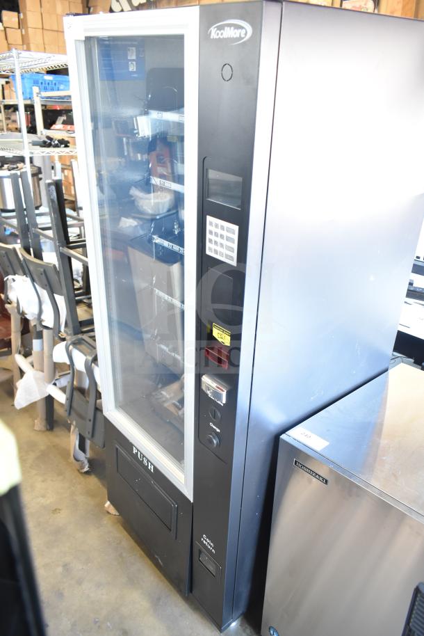Brand new KoolMore commercial vending machine, scratch and dent condition. Features keypad, coin slot, and product display.