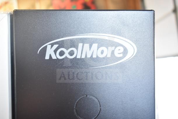 "Brand new KoolMore commercial vending machine, black finish, scratch and dent condition, visible KoolMore logo."