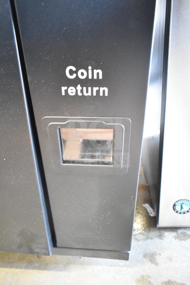 KoolMore commercial vending machine, brand new with minor scratches and dents, features visible coin return slot.