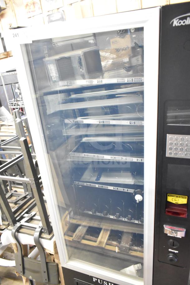 KoolMore commercial vending machine, brand new with minor scratches and dents, featuring multiple shelves and keypad.