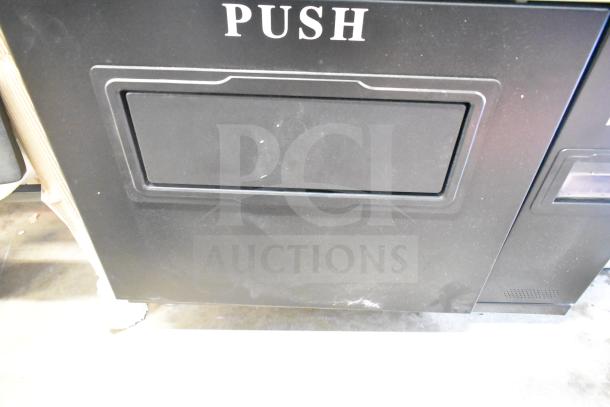 KoolMore commercial vending machine, new with minor scratches and dents. Visible "PUSH" label on exterior door.