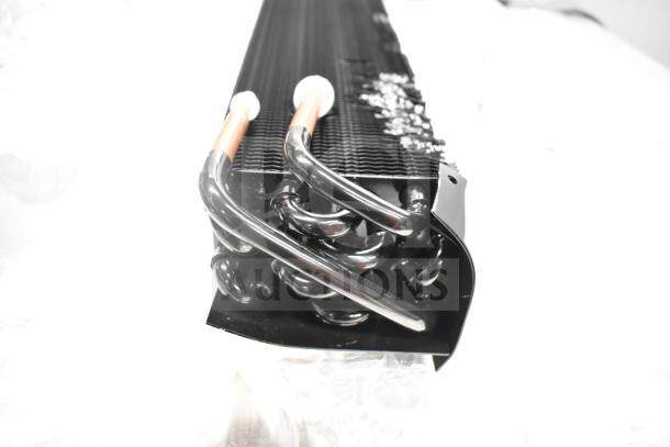 Avantco 177PMG225 evaporator coil, new with scratch and dent. Black coiling and copper pipes visible. Auction includes auger.