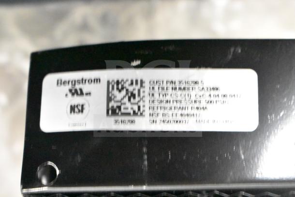 Label on Bergstrom refrigeration component. Includes NSF logo, specs: CUST P/N 3516290-5, refrigerant R404A. Black unit.