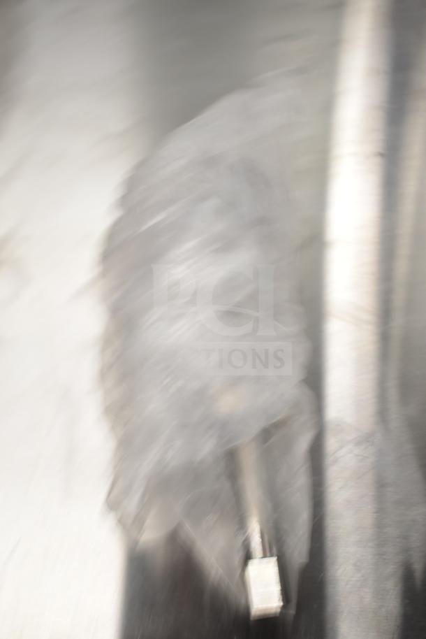 Blurry image of Avantco 177PMG225 auger and evaporator coil in packaging; new, labeled as scratch and dent.