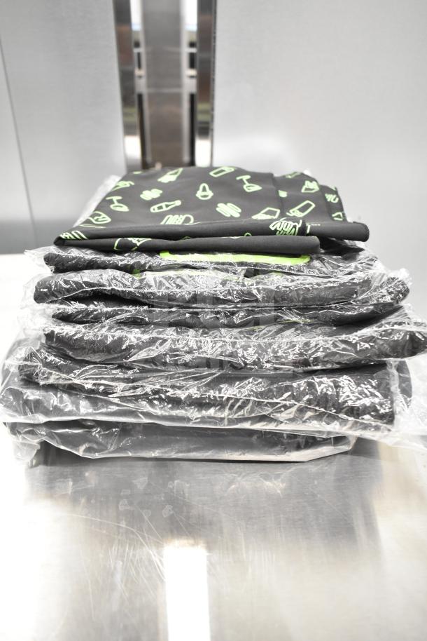Stack of 7 brand new "Scratch and Dent" Shack Staff Tees in various sizes. Each individually packaged.