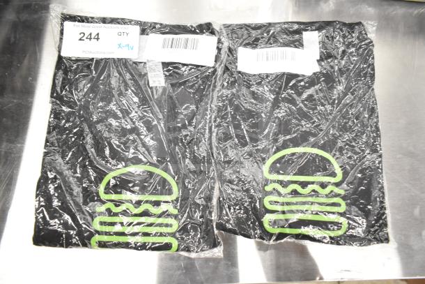 Pack of 7 new Shack Staff Tees, sizes XL, MD, 2XL, with logo. Includes item codes 2950034-00. Scratch and dent condition.