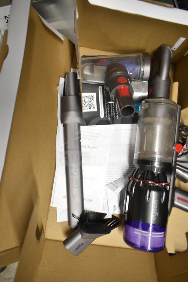 Dyson Humdinger Vacuum Cleaner parts and accessories in a box. Includes attachments and manual. Good condition.