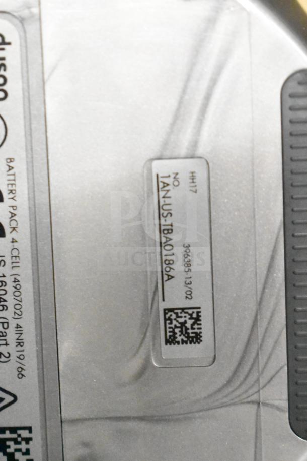 Label on Dyson Humdinger Vacuum Cleaner showing model HH17 and serial number 1AN-US-TBA0186A; battery pack info visible.