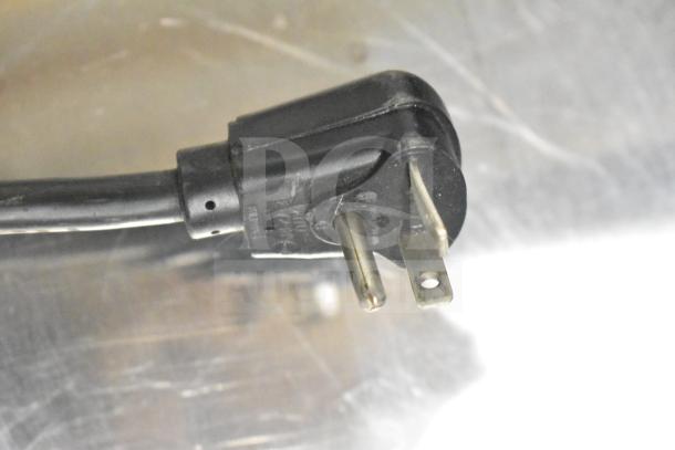 Close-up of a black power plug for a 2021 Menumaster MFS18TS commercial microwave, 208/240 volts, 1 phase.