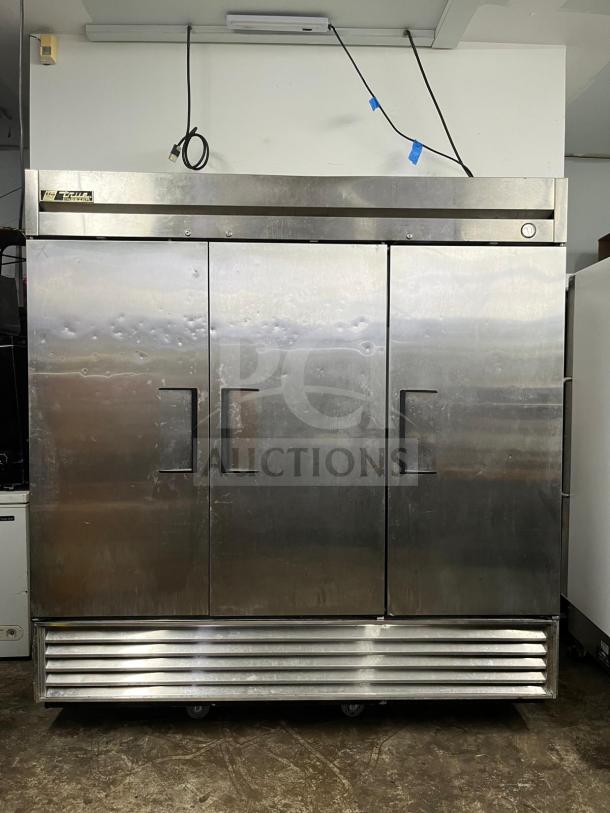 True T-72F 78" solid door reach-in freezer, stainless steel, three doors, used condition with visible wear.