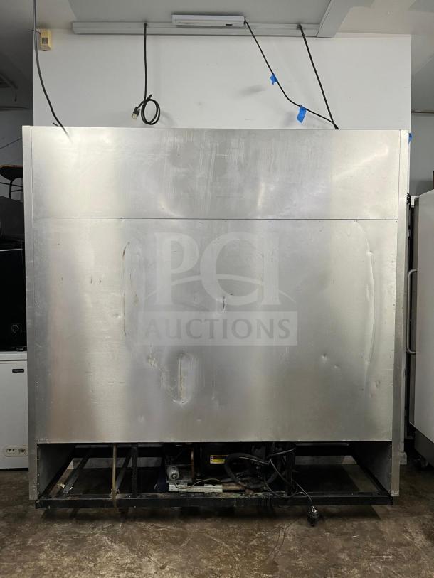 True T-72F solid door reach-in freezer, 78" wide, stainless steel, visible wear, solid construction suitable for commercial use.