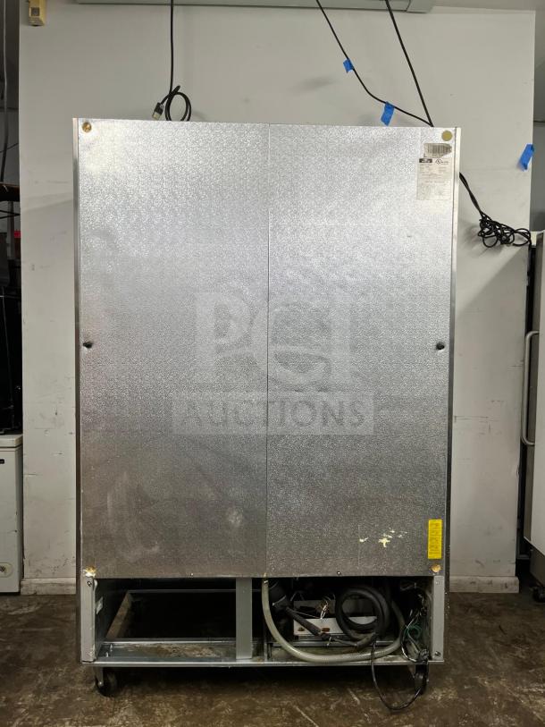 Arctic Air AF49 reach-in freezer, stainless exterior, two solid doors, visible wiring and components at the bottom, used condition.