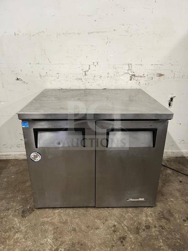 True TUC-36 undercounter cooler, stainless steel, 2-door, some wear, brand label visible.