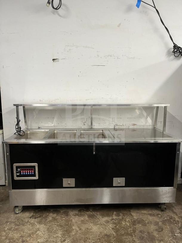 Vollrath 36291 non-refrigerated food station, stainless steel, 74"x27", three compartments, good condition, on casters.