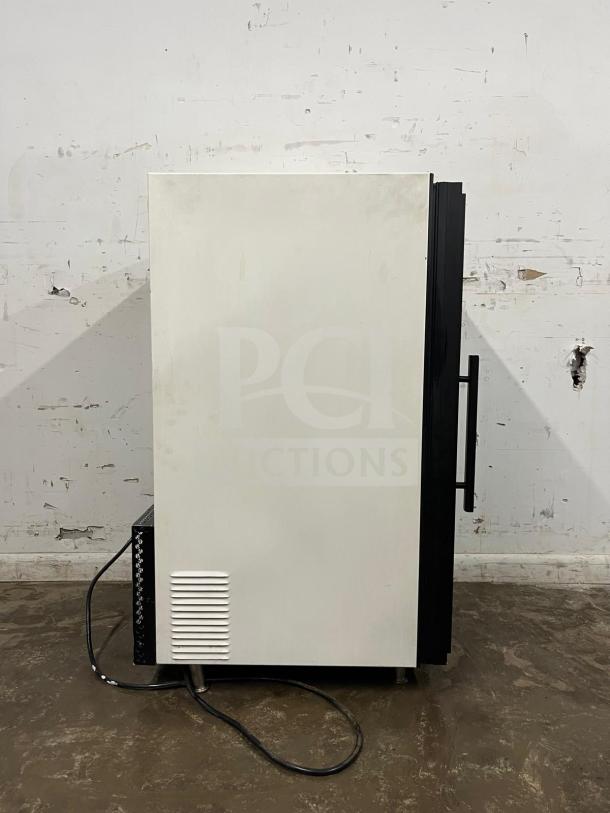Countertop display freezer, white finish, side view, with black handle. Visible power cord, good condition.