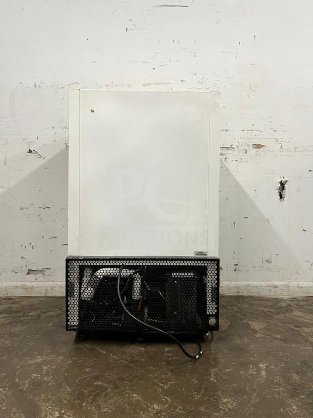 White countertop display freezer with metal grill base, moderate wear, visible compressor and wiring, suitable for retail use.