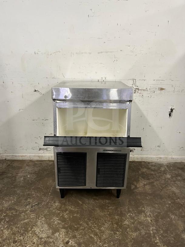 Hoshizaki 24" air-cooled cube ice machine, stainless steel, self-contained. Some surface wear, vents visible at base.