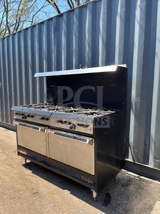 Garland Natural Gas 10 Burner Range, 60", dual ovens, 406,000 BTU, stainless finish, visible wear, model details on front.