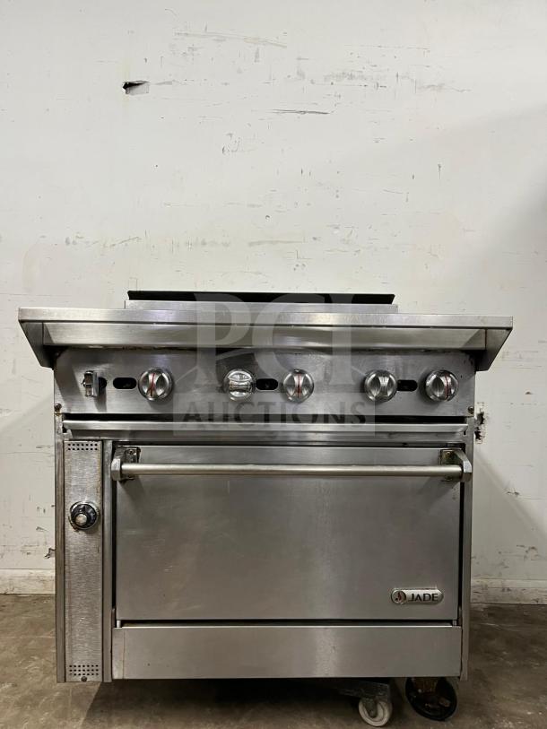 Jade Range Oven, 6 burners, 35,000 BTU, stainless steel, visible Jade logo and control knobs, on wheels, good condition.