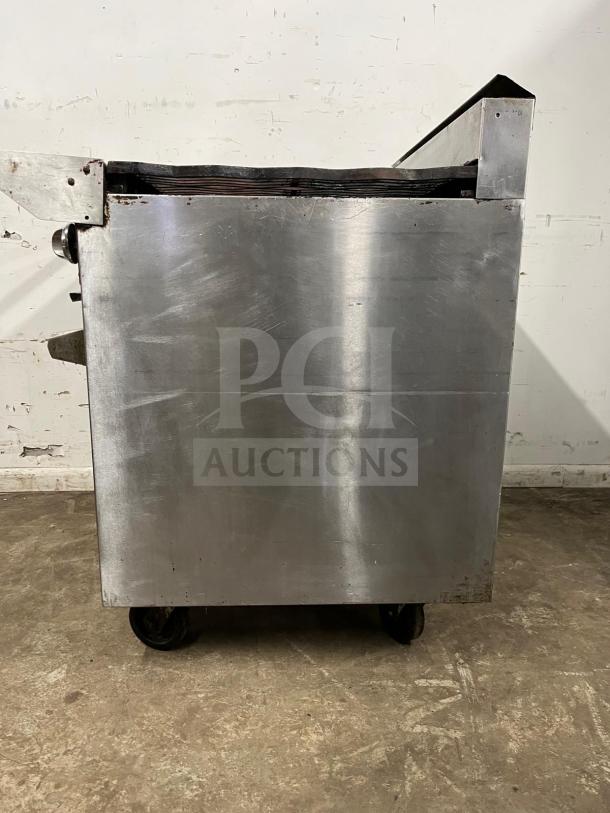 Jade Range Oven, 6 Burners, 35000 BTU, stainless steel, side view, on wheels, used condition.