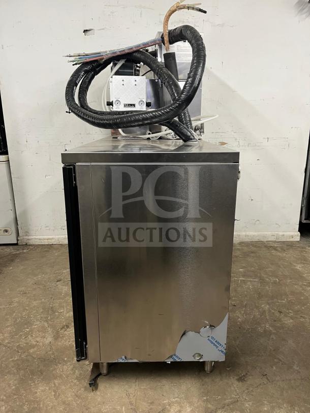 Perlick DDS60 black beer dispenser, 60" length, fits five 1/4 kegs, visible wear on lower panel, coiled tubing on top.