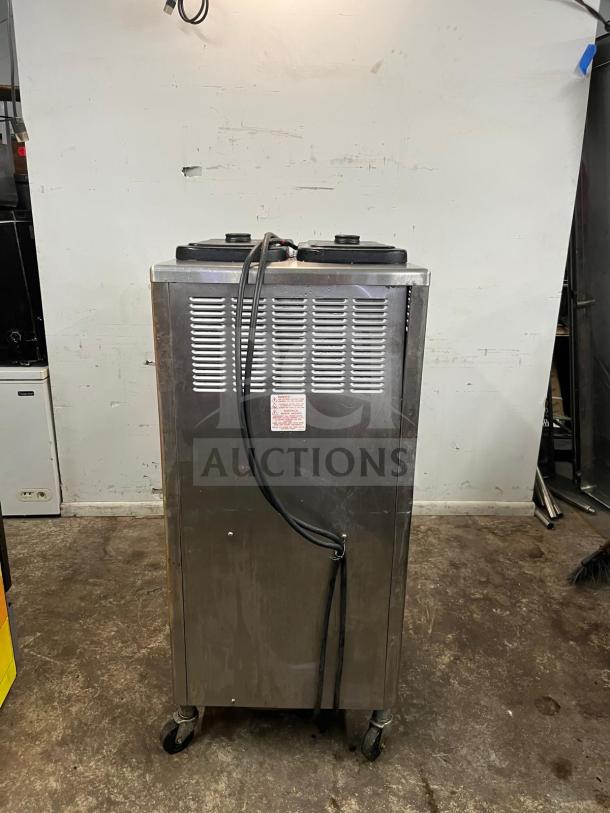 Taylor 342D Double Flavor frozen drink machine, stainless steel, sturdy casters, good condition, dual spout controls.