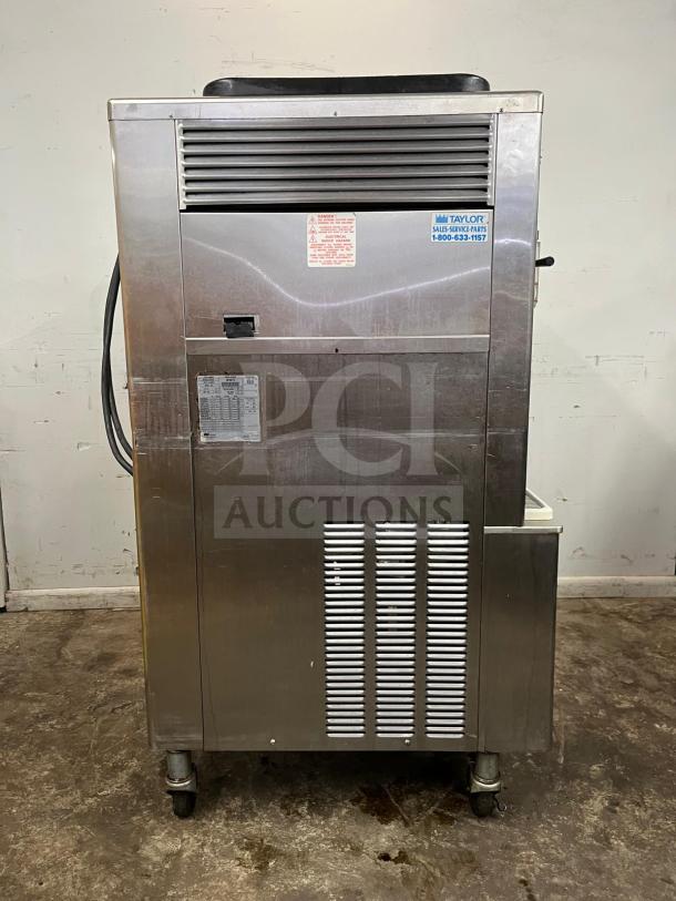 Taylor 342D double flavor frozen drink machine for margaritas or milkshakes, features stainless steel body, intact labels, wheels for mobility.