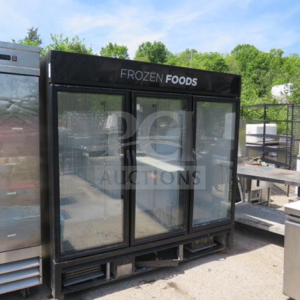 Three-door True glass display freezer with six racks, model GDM-72F-HC, featuring "FROZEN FOODS" signage.