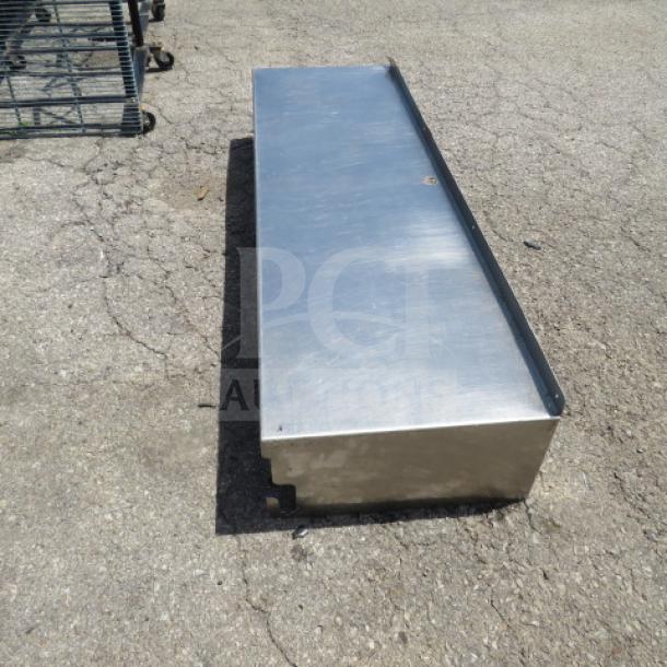 Stainless steel shelf, 60x18x10.5 inches, good condition, robust construction, ideal for industrial or kitchen use.
