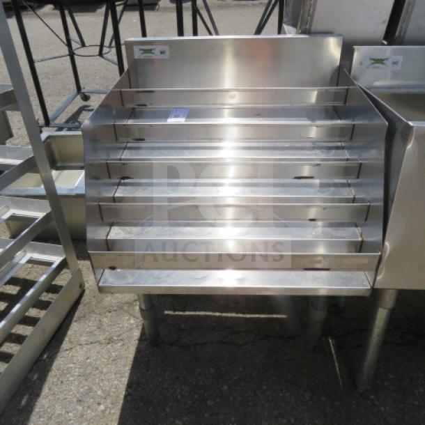 Regency stainless steel 5-tier liquor display, Model 600LDR2334, measures 24x23x32 inches, in good condition.