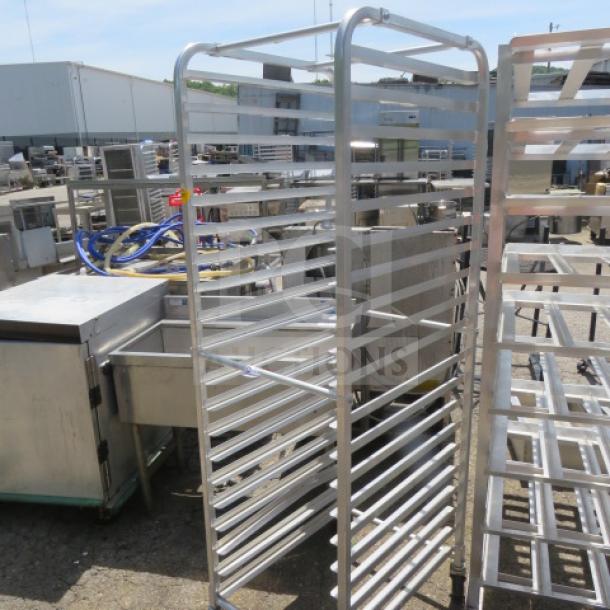 Regency Aluminum Speed Rack on casters, Model 109RACKECON, 21x26x69 inches, multiple shelves, outdoor setting.