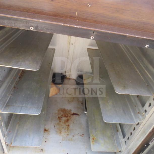 Crescor Heat and Hold unit on casters, interior view, 26x30x36 inches, visible shelving, used condition.