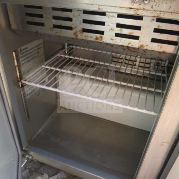 Avantco 2-door refrigerated prep table, model 178APT48MHC, with cutting board and 2 racks, on casters, shown open.